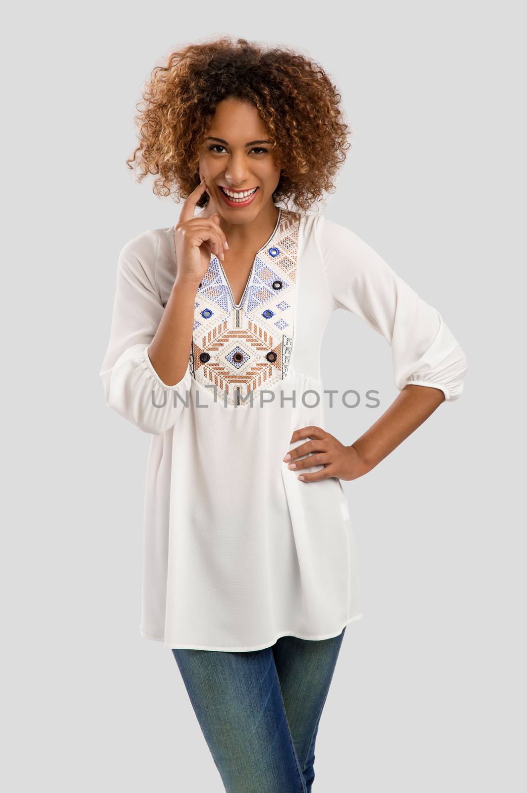 Beautiful African American woman smiling, isolated over a gray background