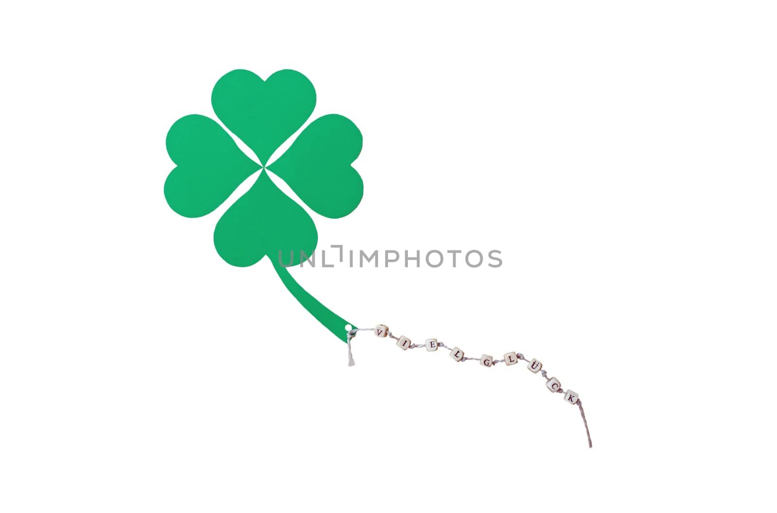 The german words for Good Luck and a cloverleaf on a cord, isolated on white