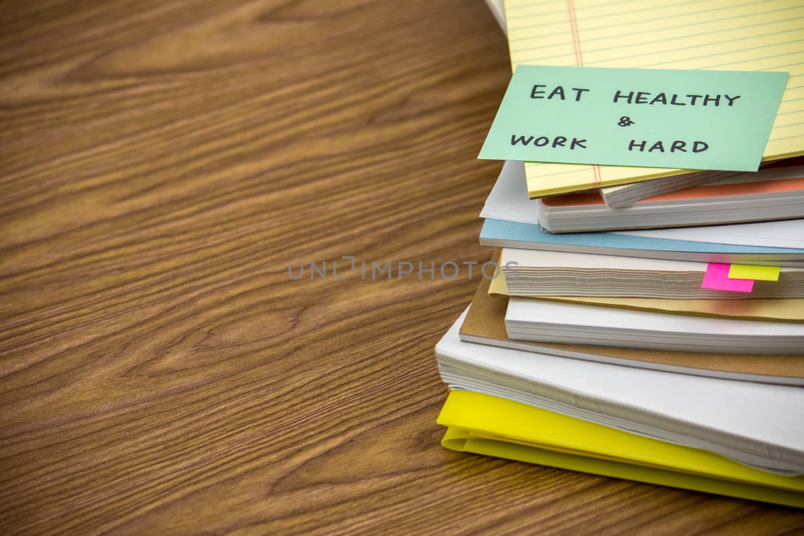 Eat Healthy Work Hard; The Pile of Business Documents on the Desk