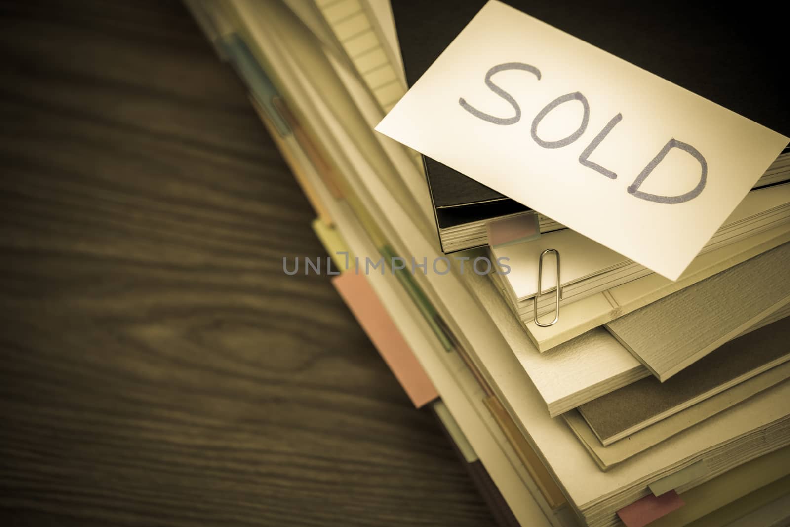 Sold; The Pile of Business Documents on the Desk