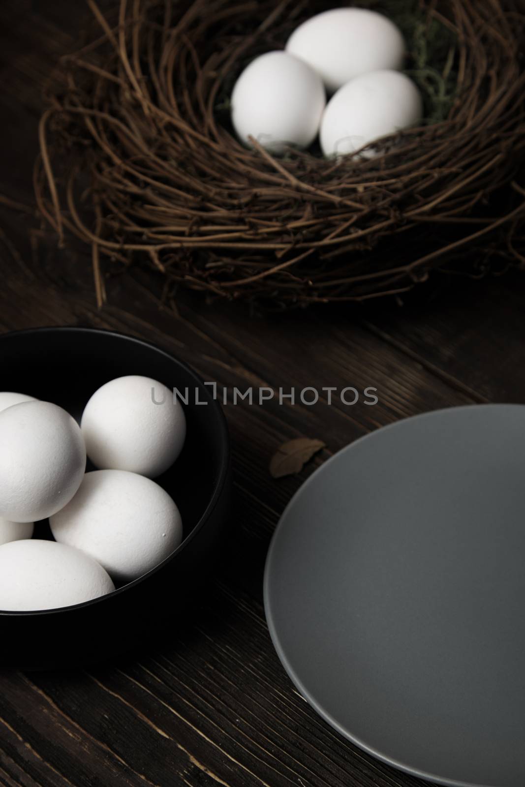 Easter eggs and bird nest on a rustic wooden table