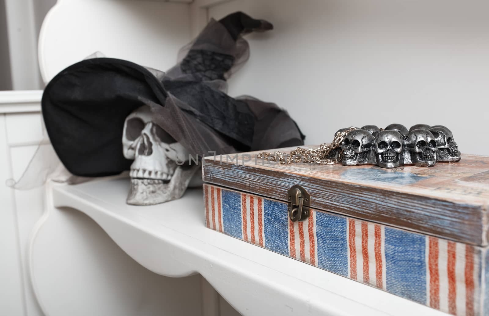 Human skull in a white cabinet. Halloween theme