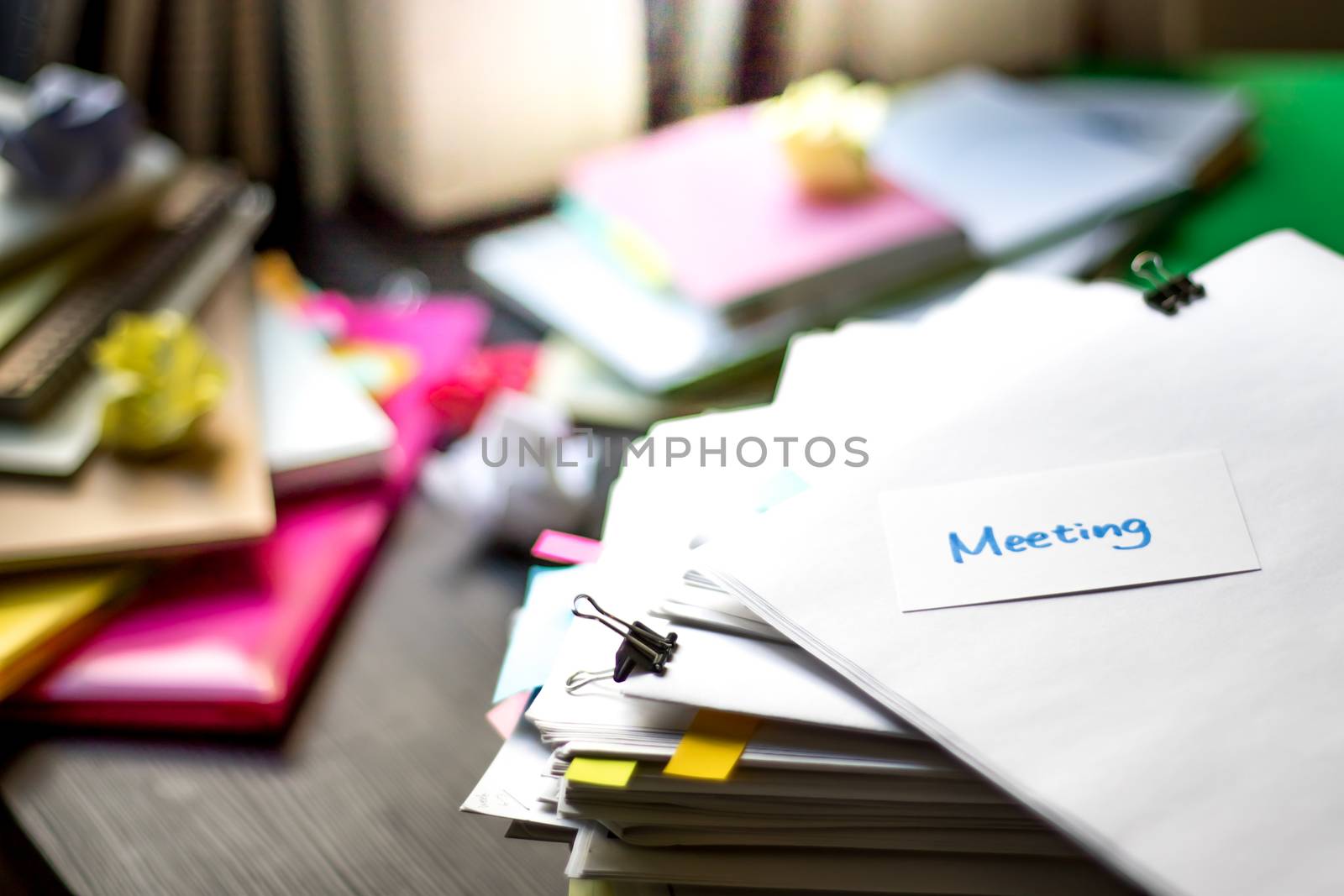 Meeting; Stack of Documents. Working or Studying at messy desk.