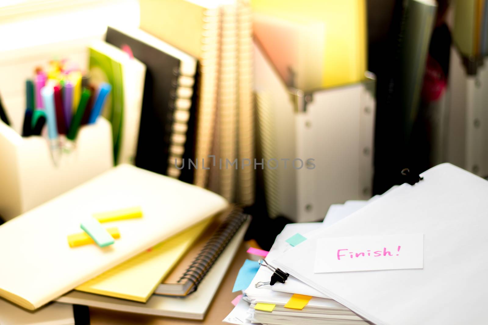 Finish; Stack of Documents. Working or Studying at messy desk.