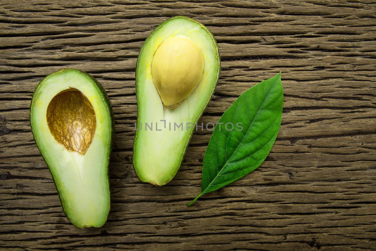 Avocado on a brown wood background.