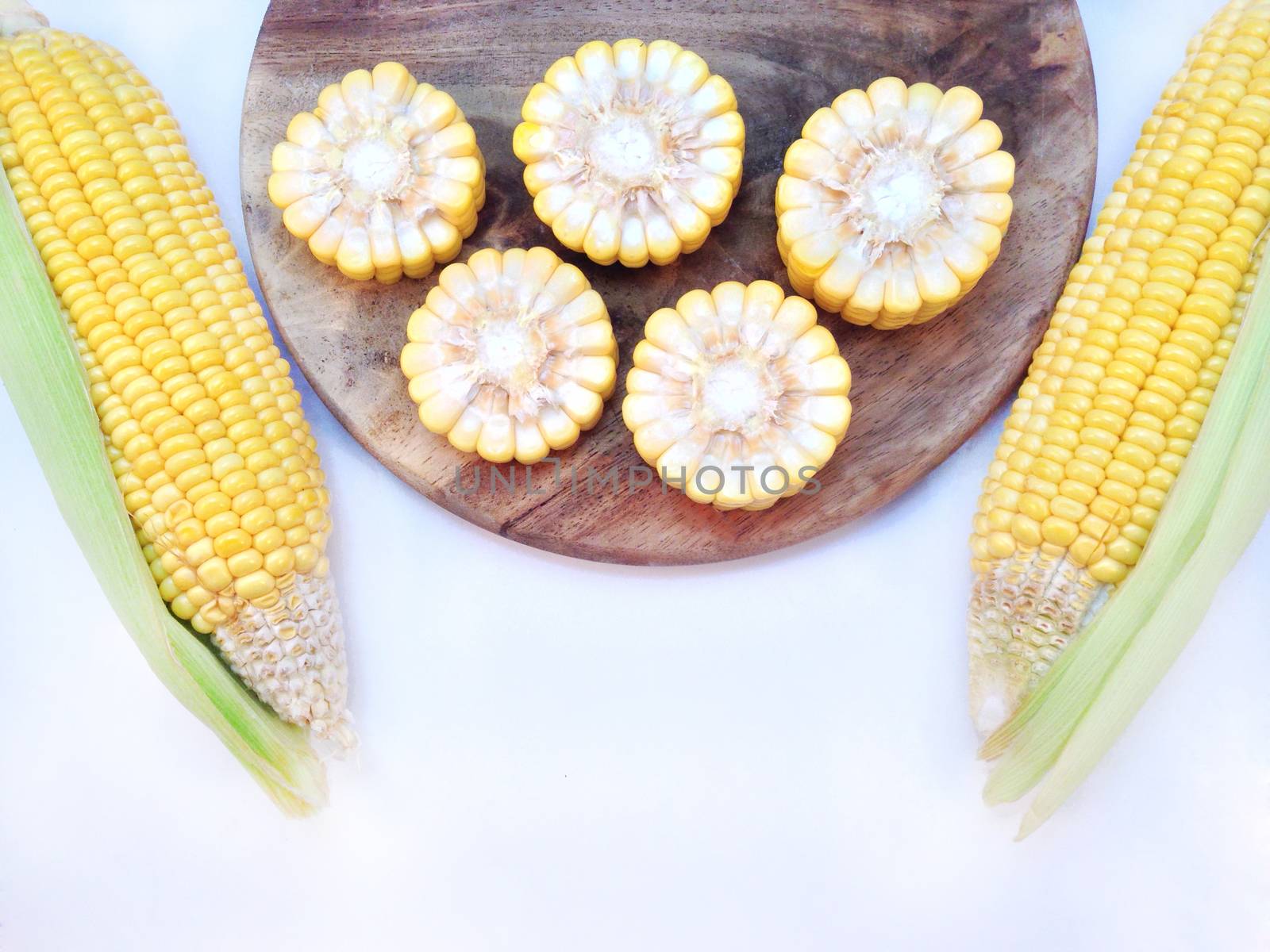 Corn with cutting board on white background