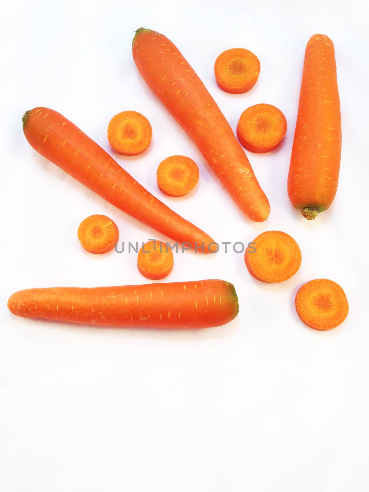 Carrot and cut pieces isolated on white background