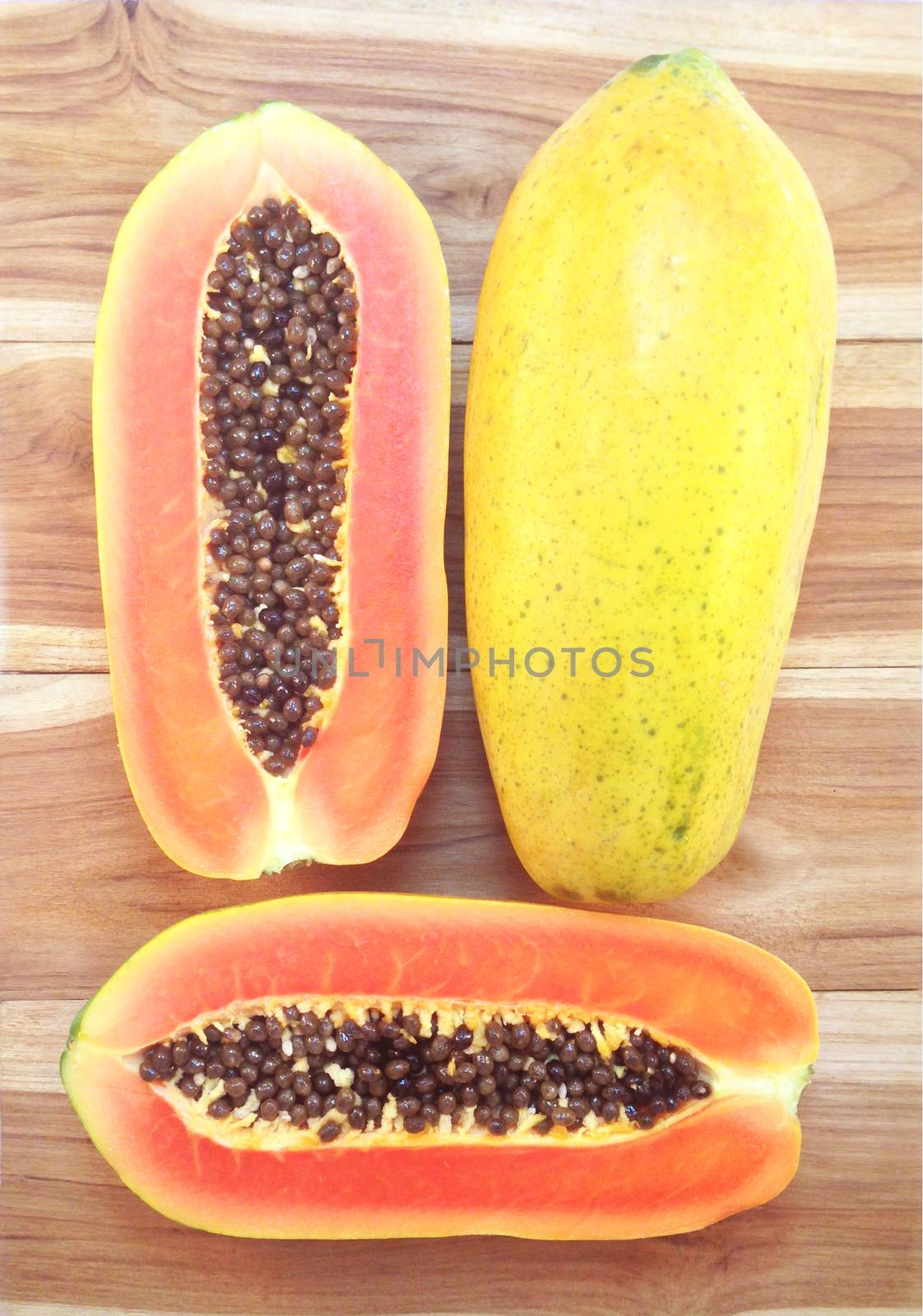 Sweet papaya on wooden background by Bowonpat