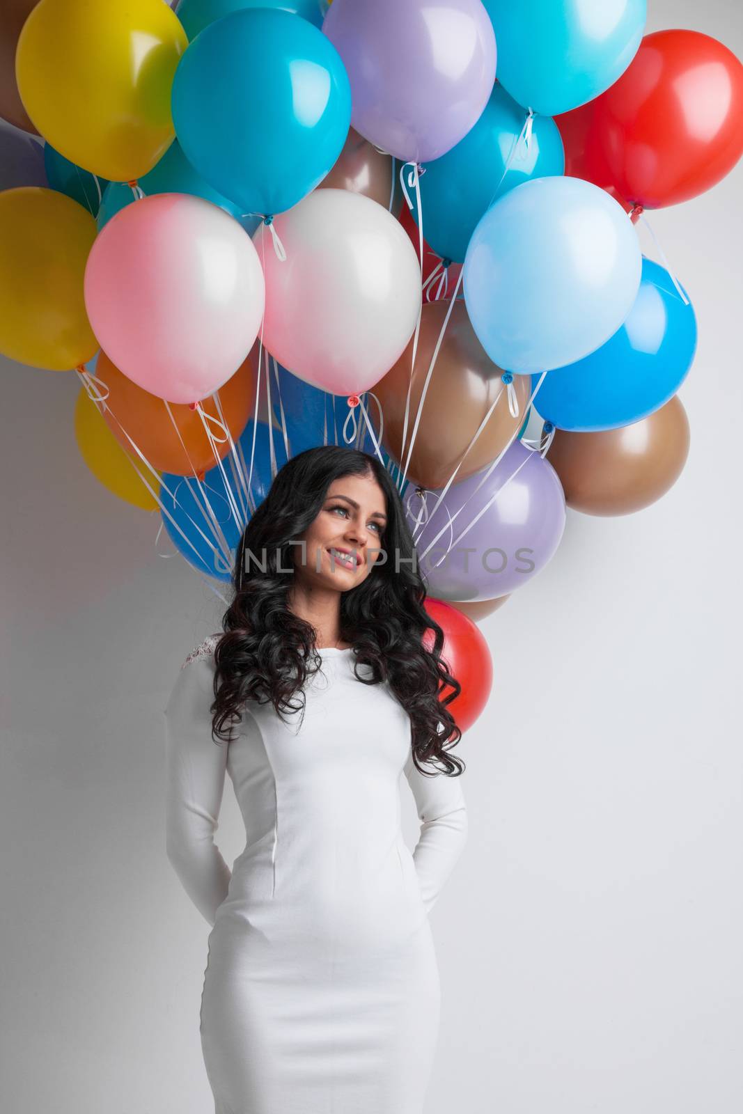 Happy woman with many colorful balloons