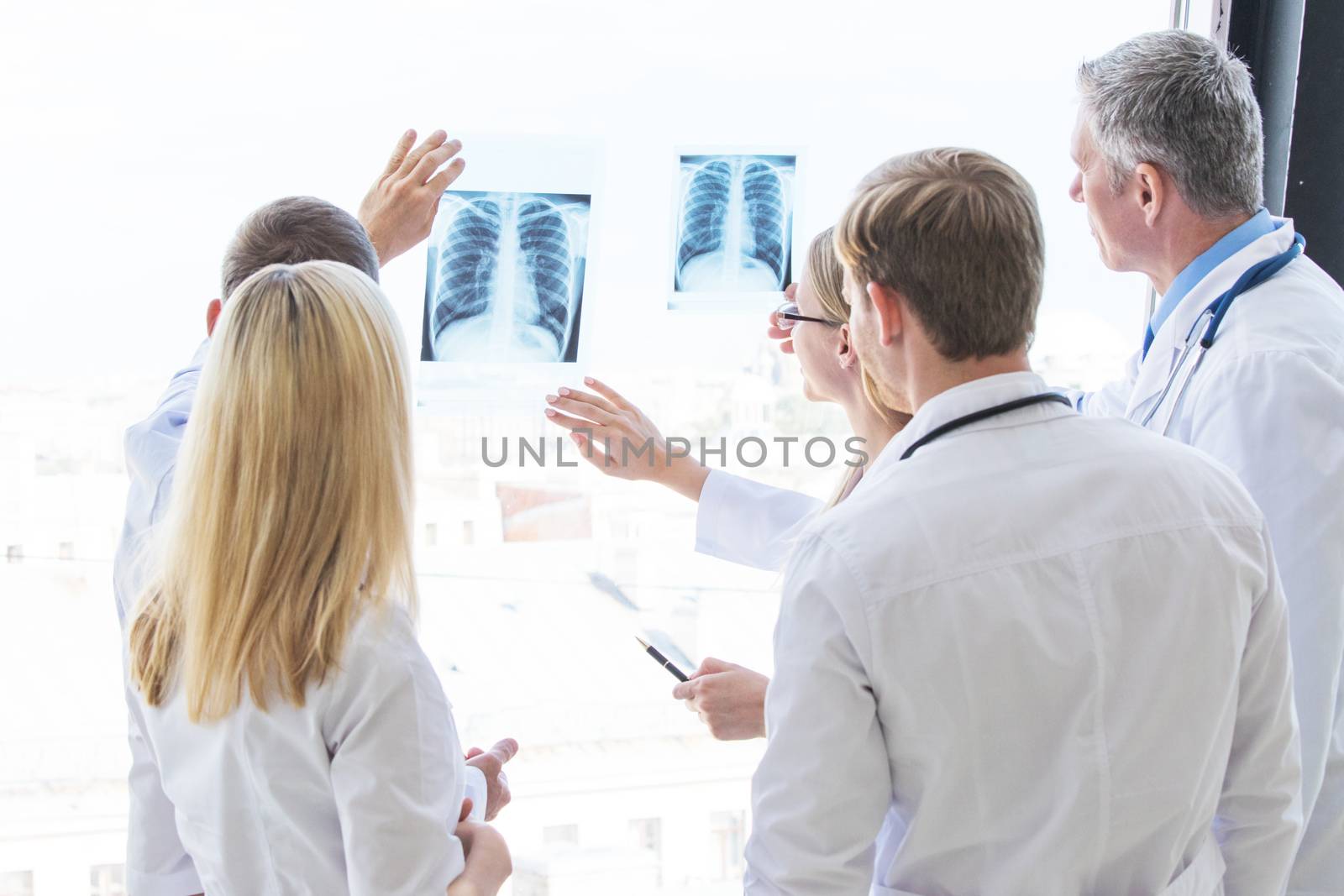 Group of doctors discuss x-ray by Yellowj