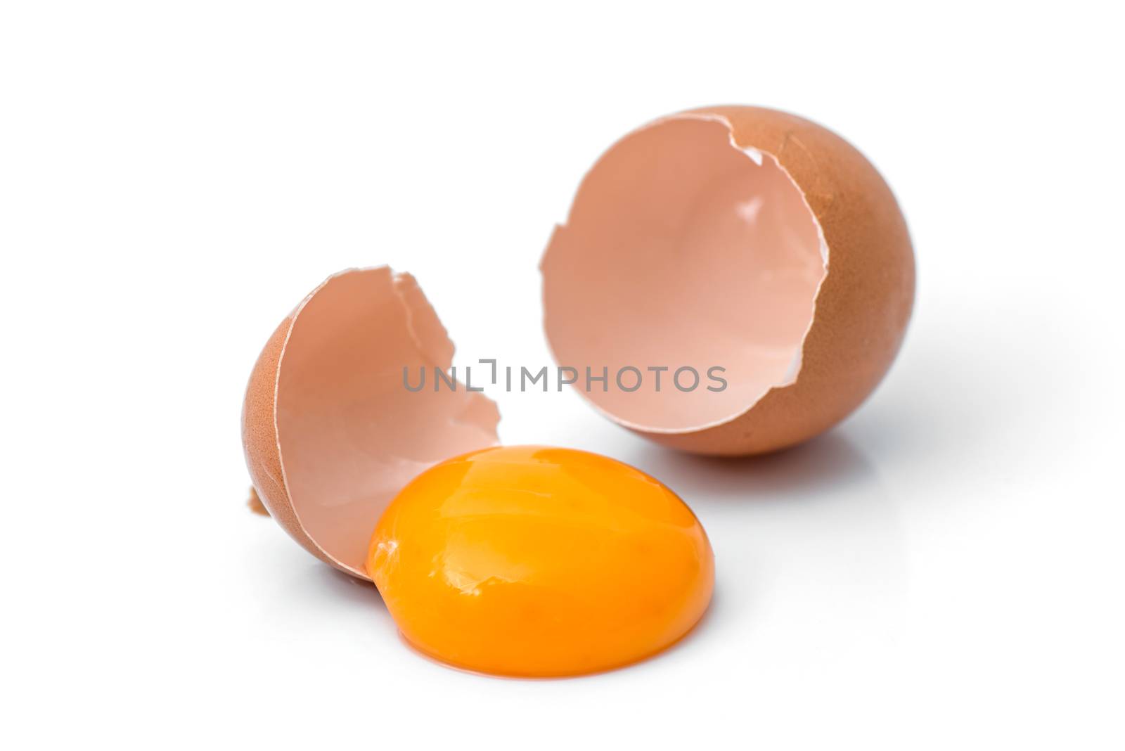 egg yolk in egg shell, cracked egg white isolated on white backg by antpkr