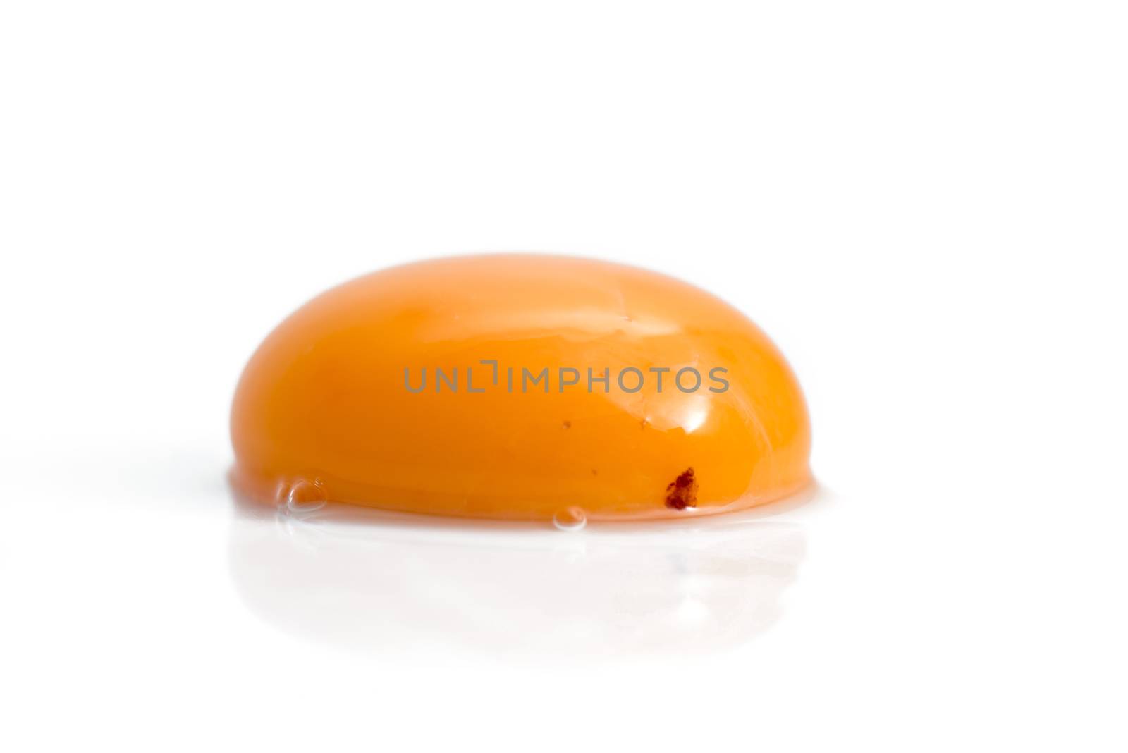 raw egg yolk isolated on white background by antpkr