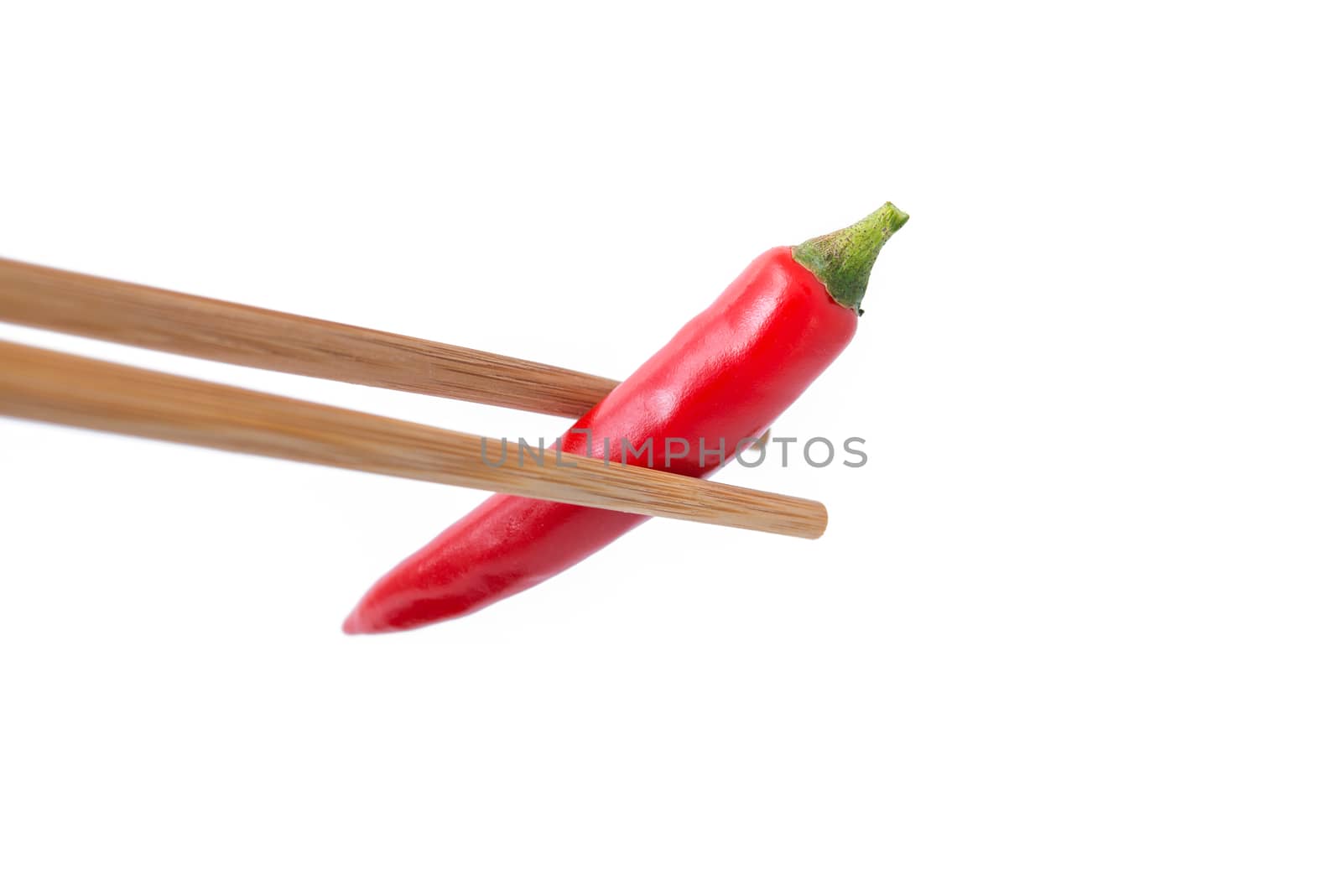 eating red hot pepper with chopsticks isolated on white backgrou by antpkr