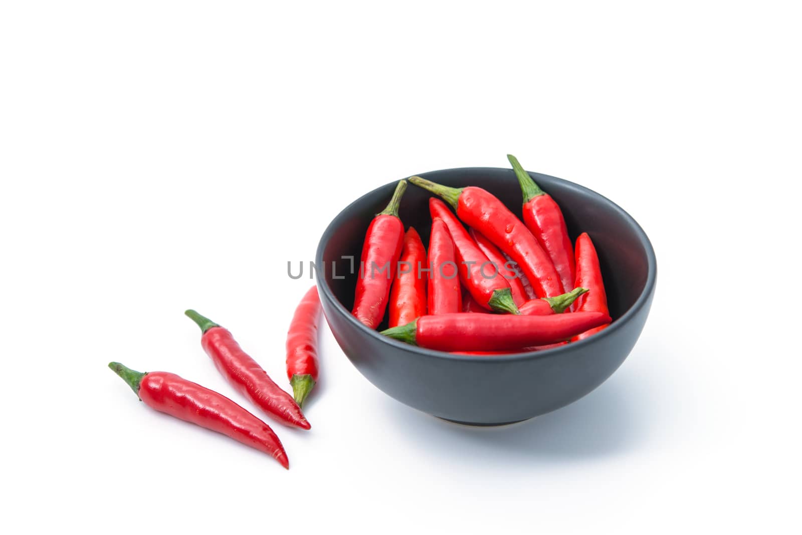 red pepper in a bowl isolated on white background by antpkr