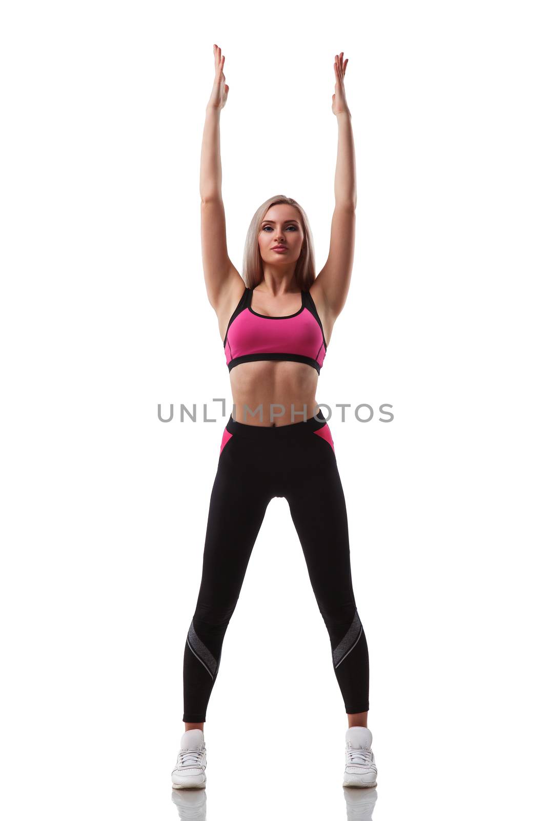 Young attractive woman practicing yoga, doing exercise working out stretching hands up, wearing sportswear, isolated on white background