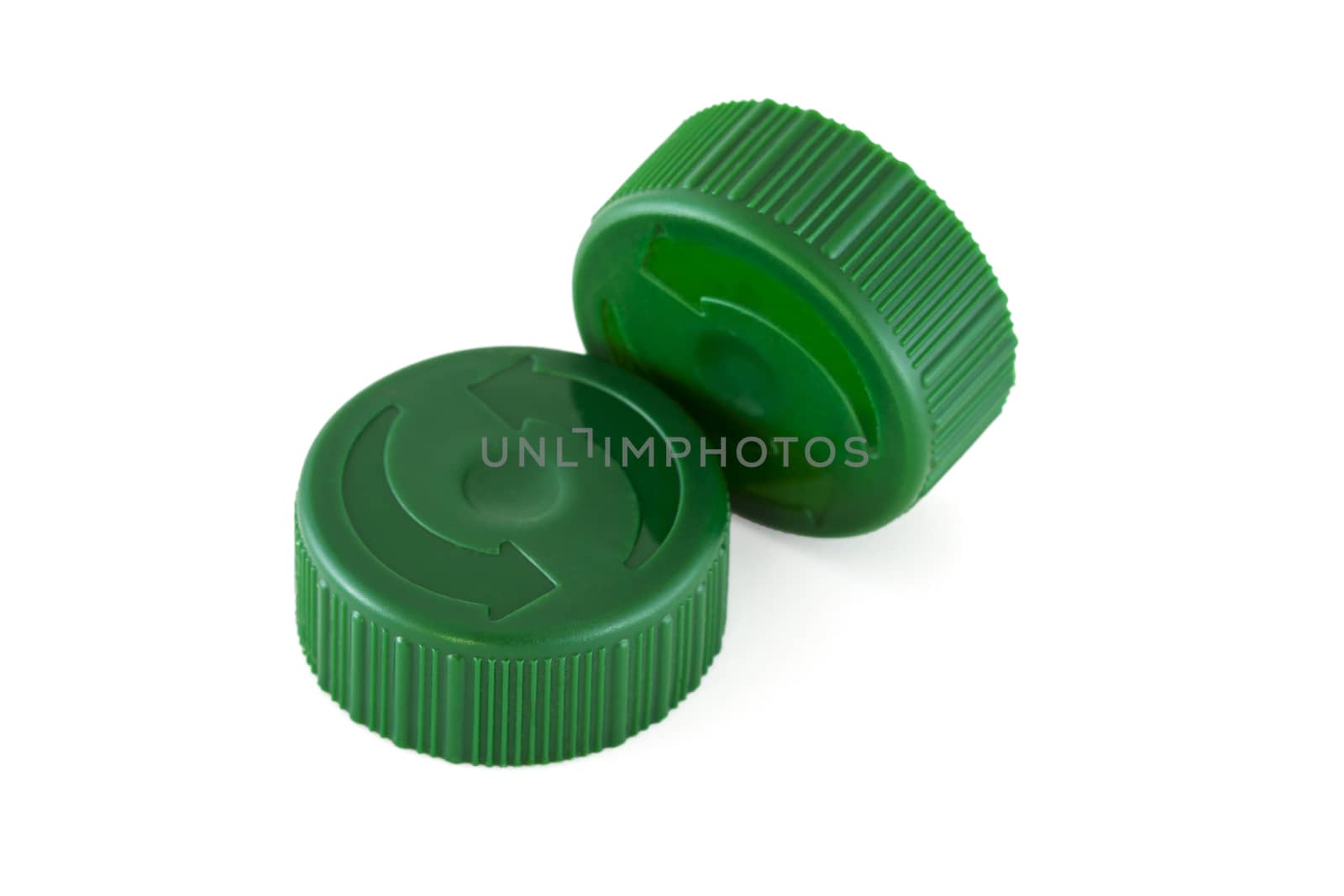 Two green plastic bottle caps isolated on white