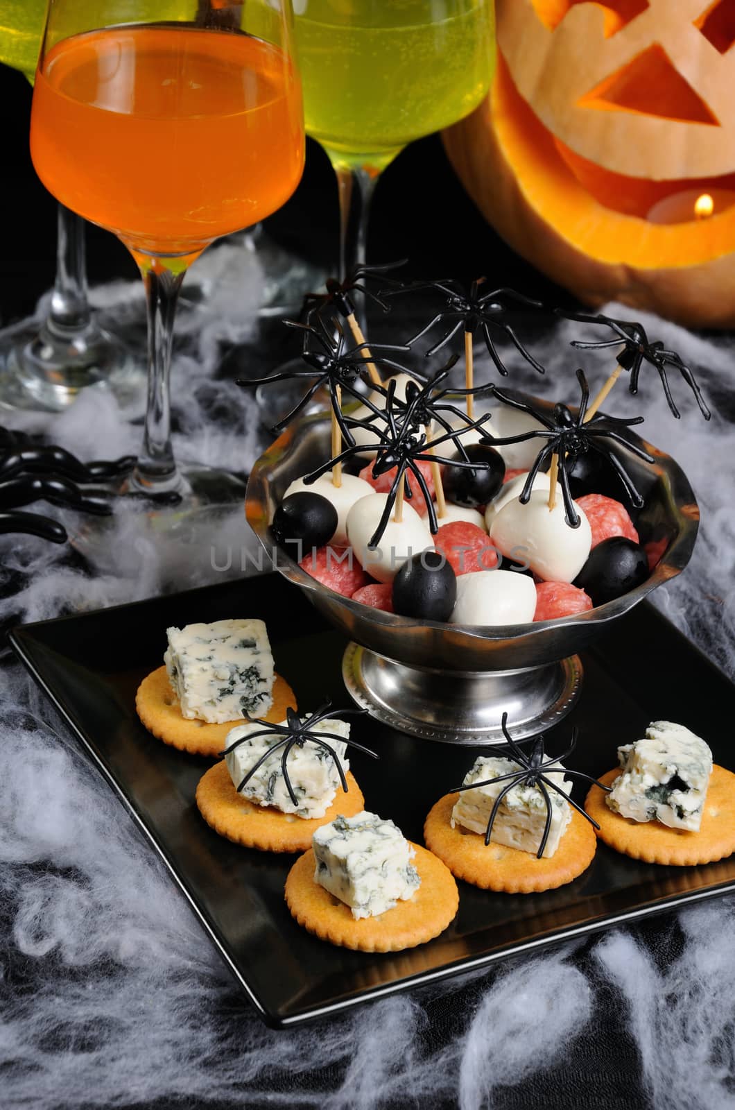 buffet   snack of cracker with blue cheese and bowl  baby salami, mozzarella, olives on the table in honor of Halloween