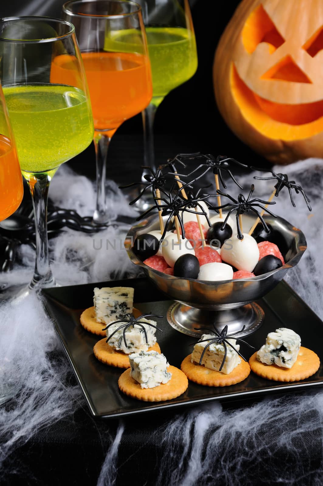 buffet   snack of cracker with blue cheese and bowl  baby salami, mozzarella, olives on the table in honor of Halloween
