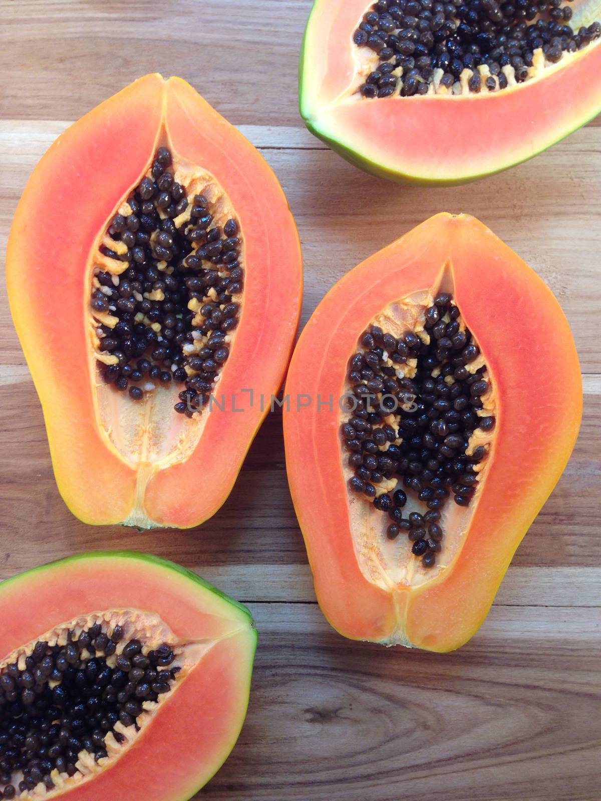 Sweet papaya on wooden background by Bowonpat