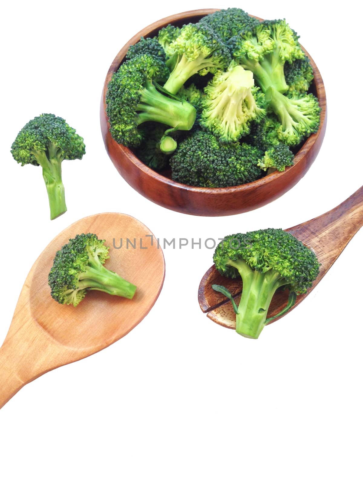 Broccoli in wooden bowl and wooden spoon on white background by Bowonpat