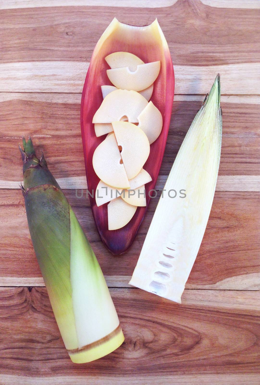 Bamboo shoots and Bamboo shoots slices on banana Blossom on wood by Bowonpat