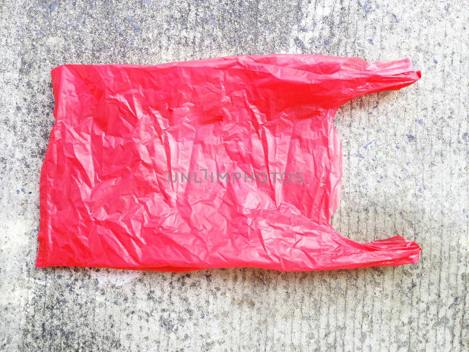 plastic bag on cement floor by Bowonpat