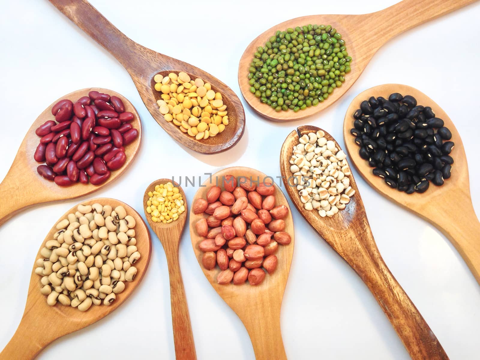 Varieties of beans, peas on white background by Bowonpat