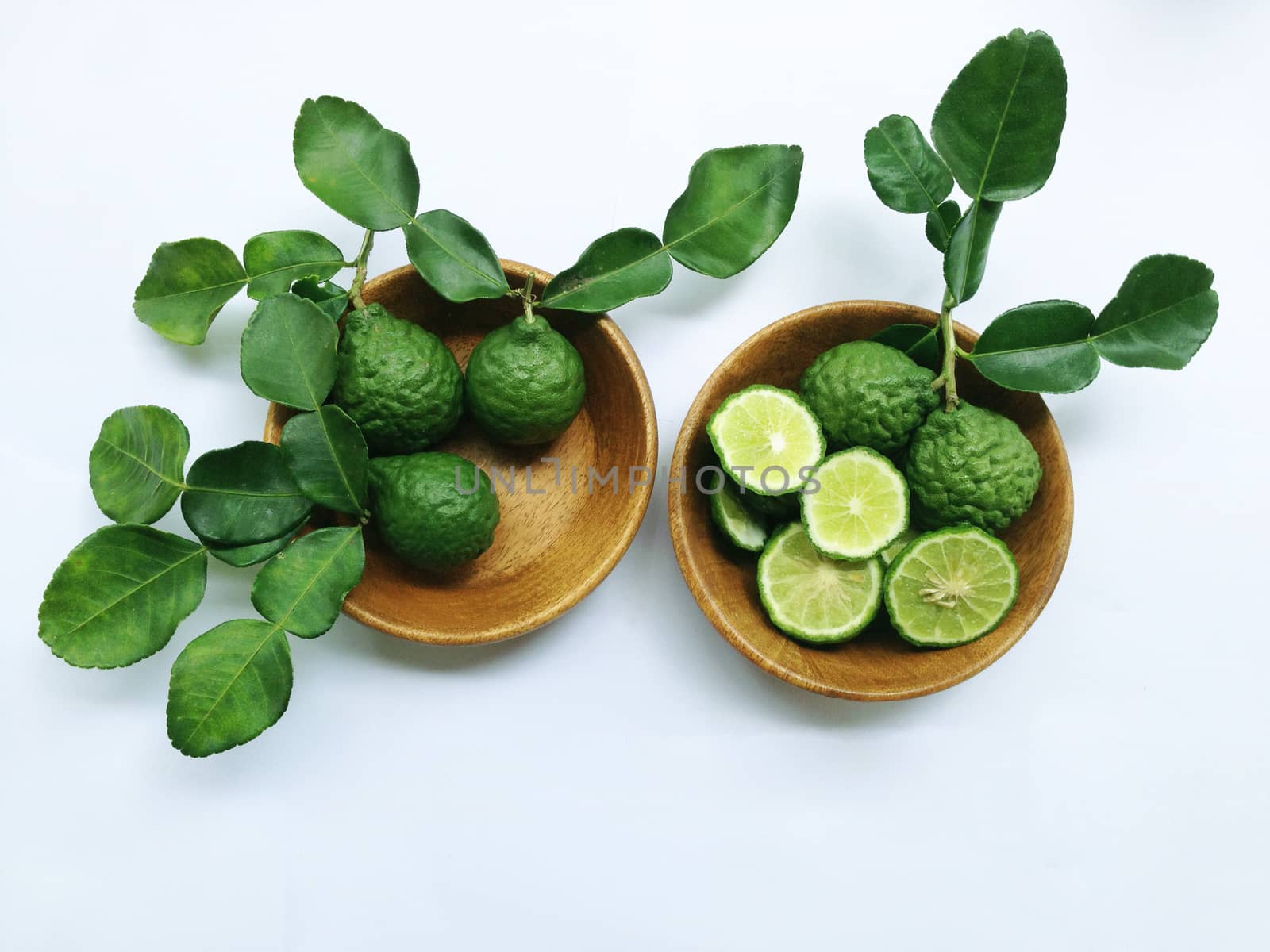 Kaffir Lime or Bergamot in wooden bowl on white background
