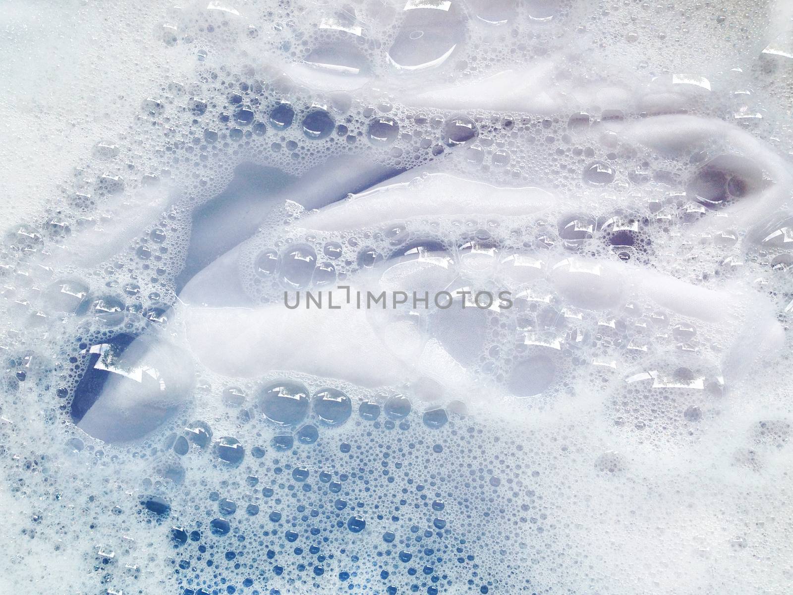 Soak a cloth before washing, white cloth  by Bowonpat