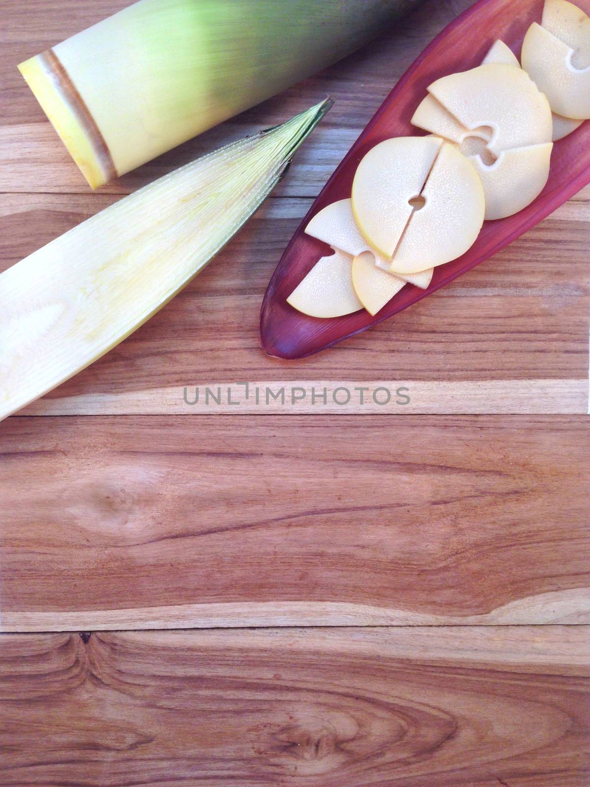 Bamboo shoots and Bamboo shoots slices on banana Blossom on wood by Bowonpat