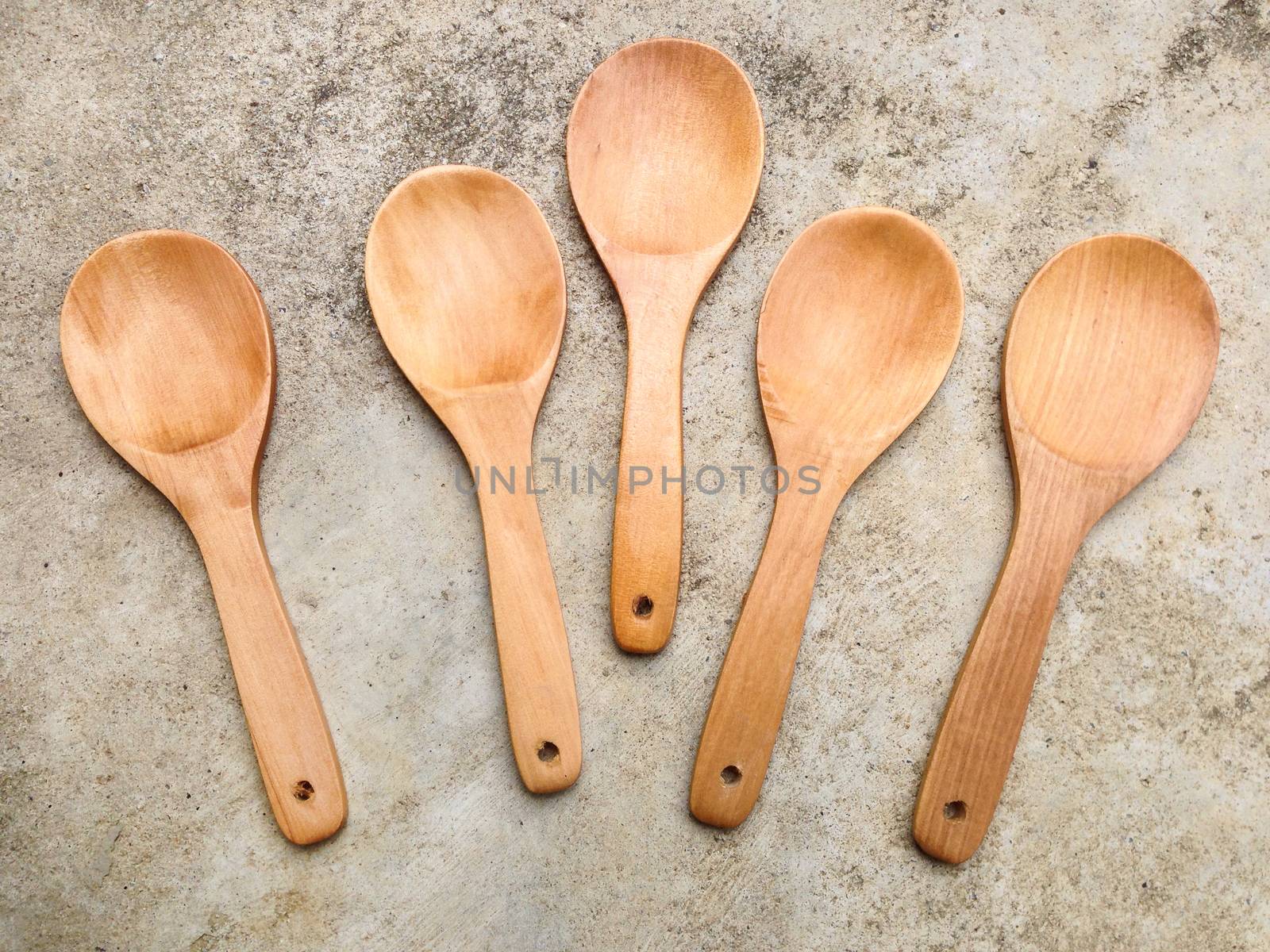 Wooden ladle on cement background