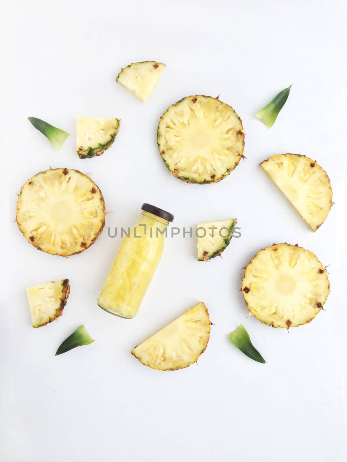 Fresh pineapple drinks and pineapple slices with leaves