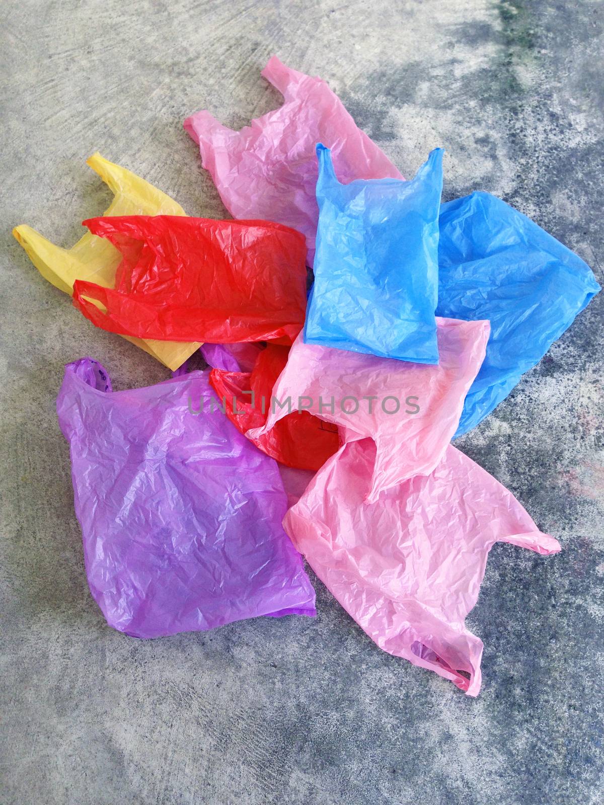 Colorful plastic bag on cement floor