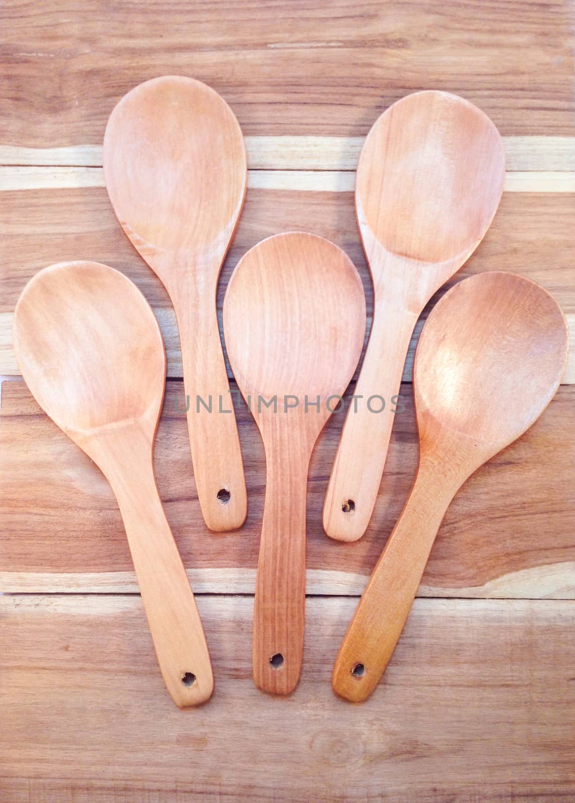 Wooden ladle on wooden background by Bowonpat