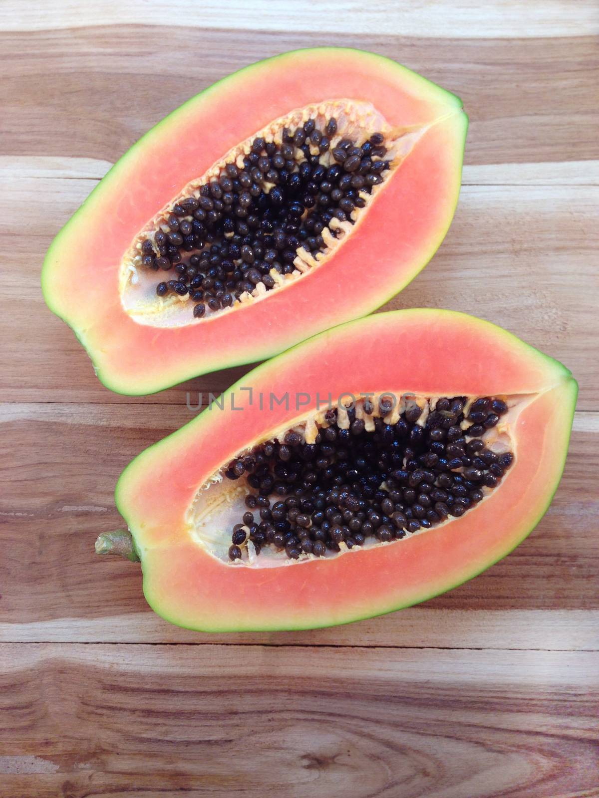 Sweet papaya on wooden background by Bowonpat