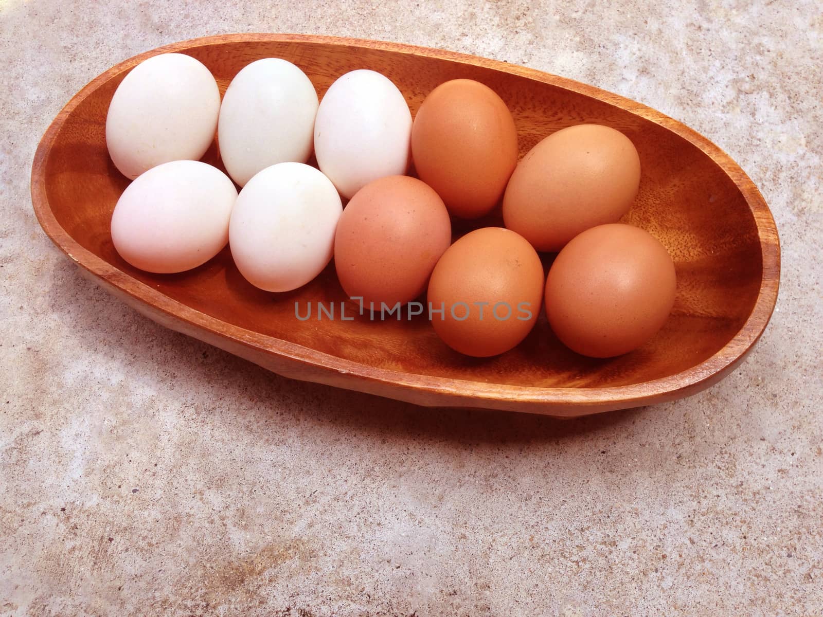 Eggs on wooden bowl