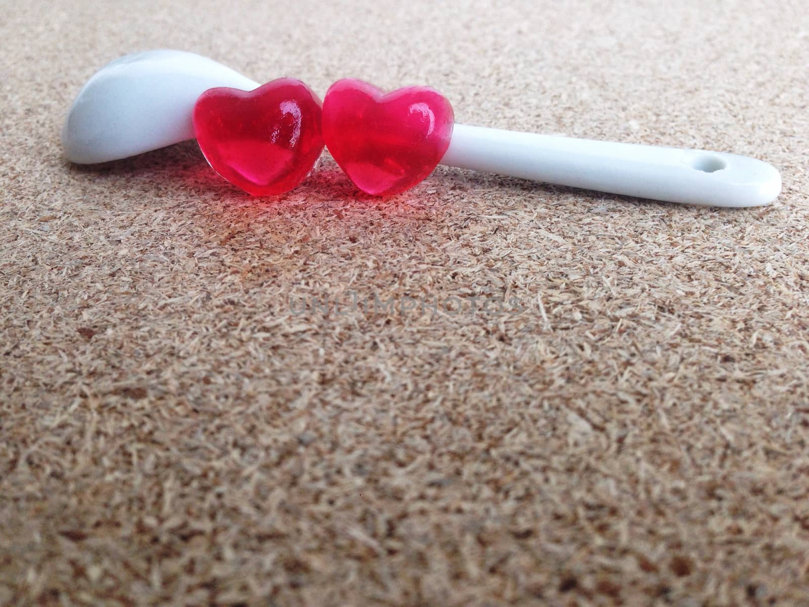 Mini heart couple with white little spoon on plywood by Bowonpat