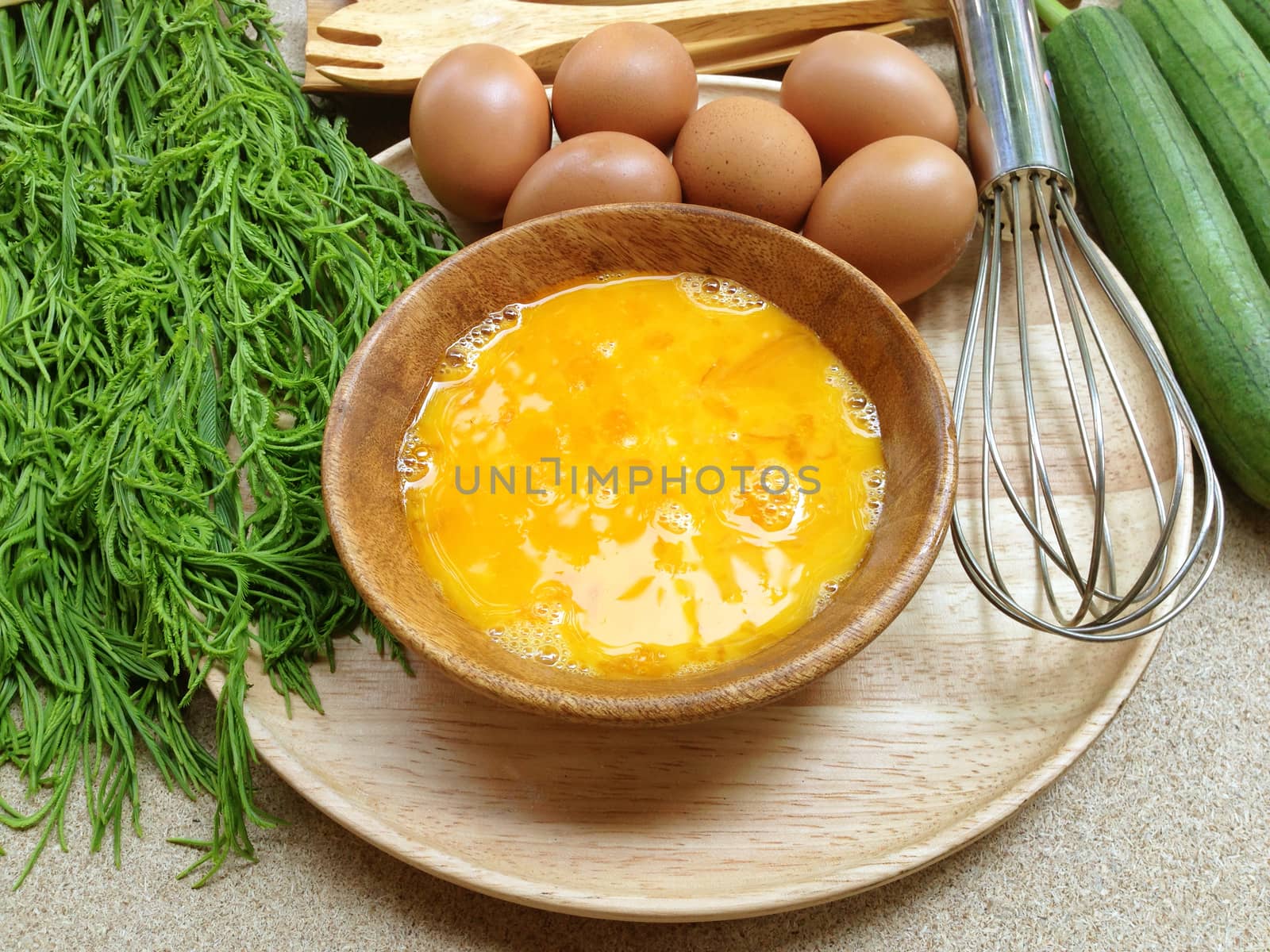 Fresh eggs in wooden bowl with eggs, egg whisk, angle gourd and  by Bowonpat