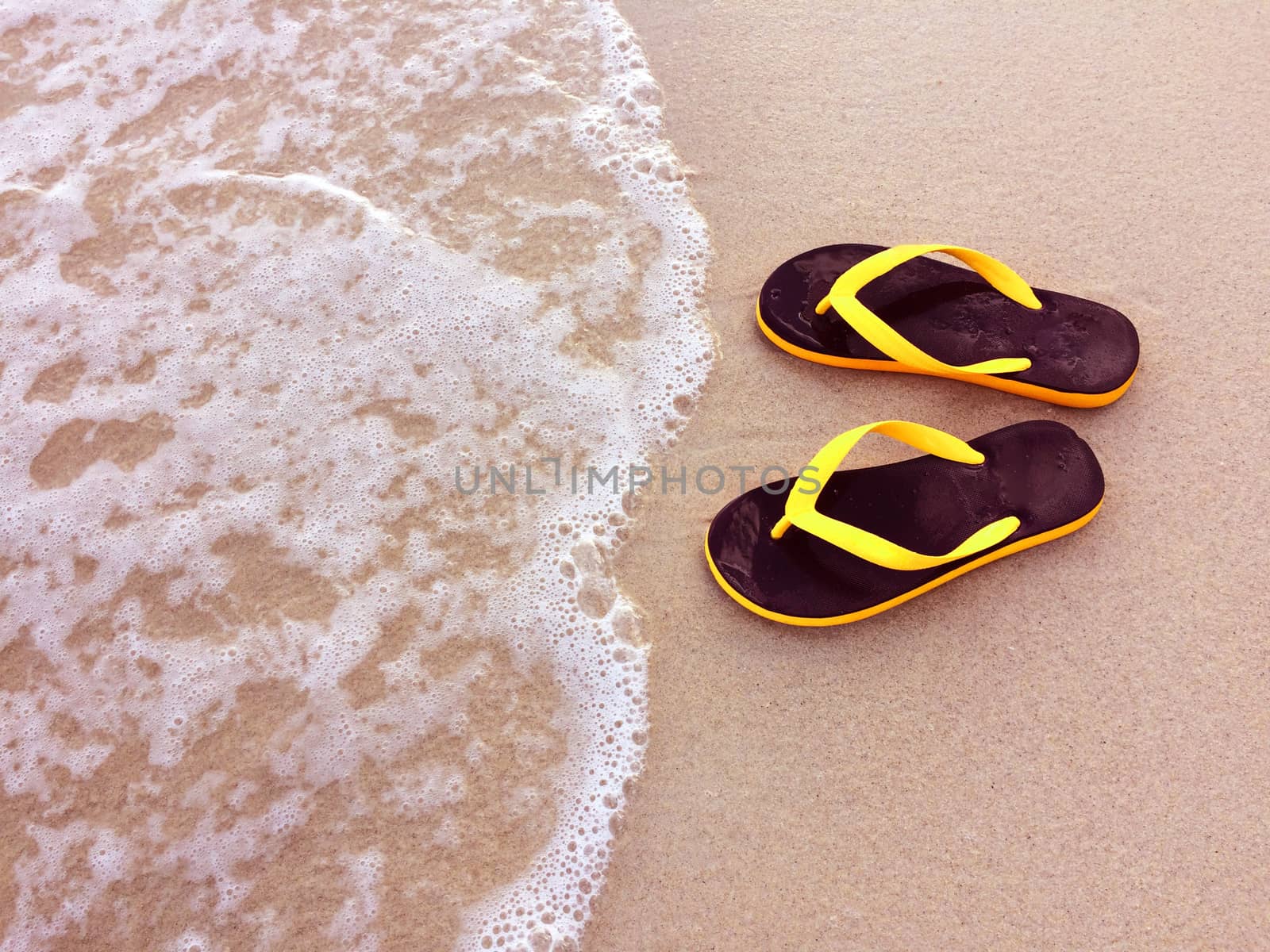 Sandals in the beach. by Bowonpat