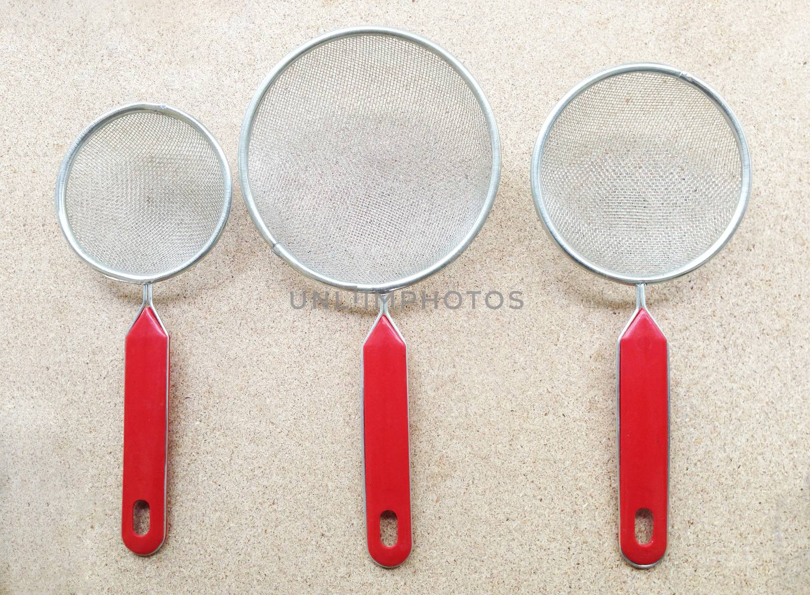 Colander  isolated on plywood background