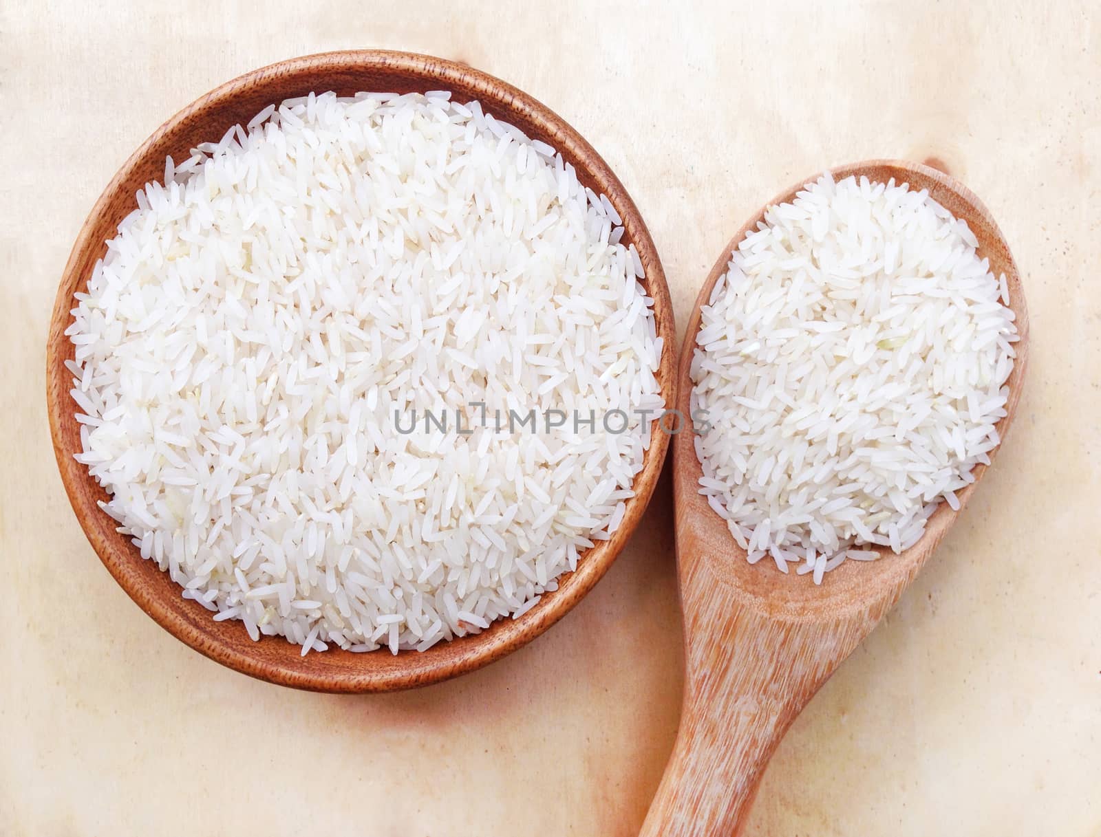 Thai rice on wooden background by Bowonpat