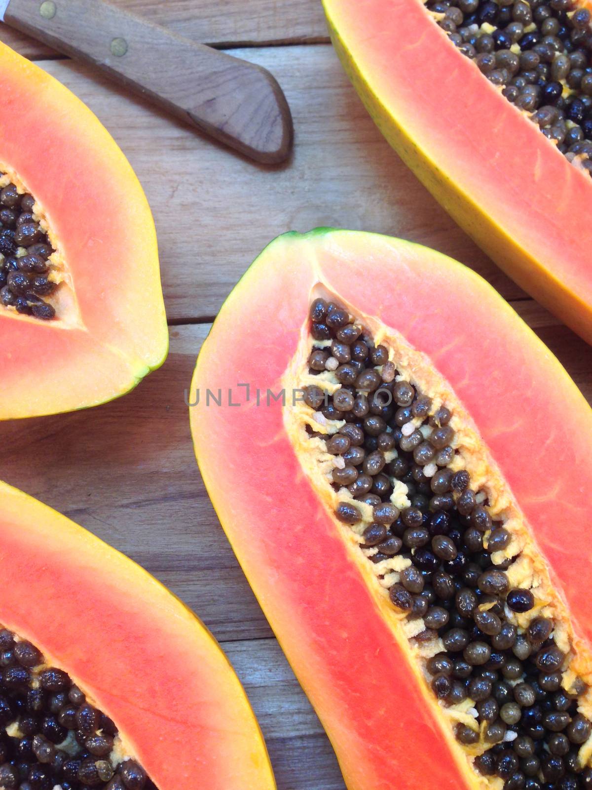 Sweet papaya on wooden background by Bowonpat