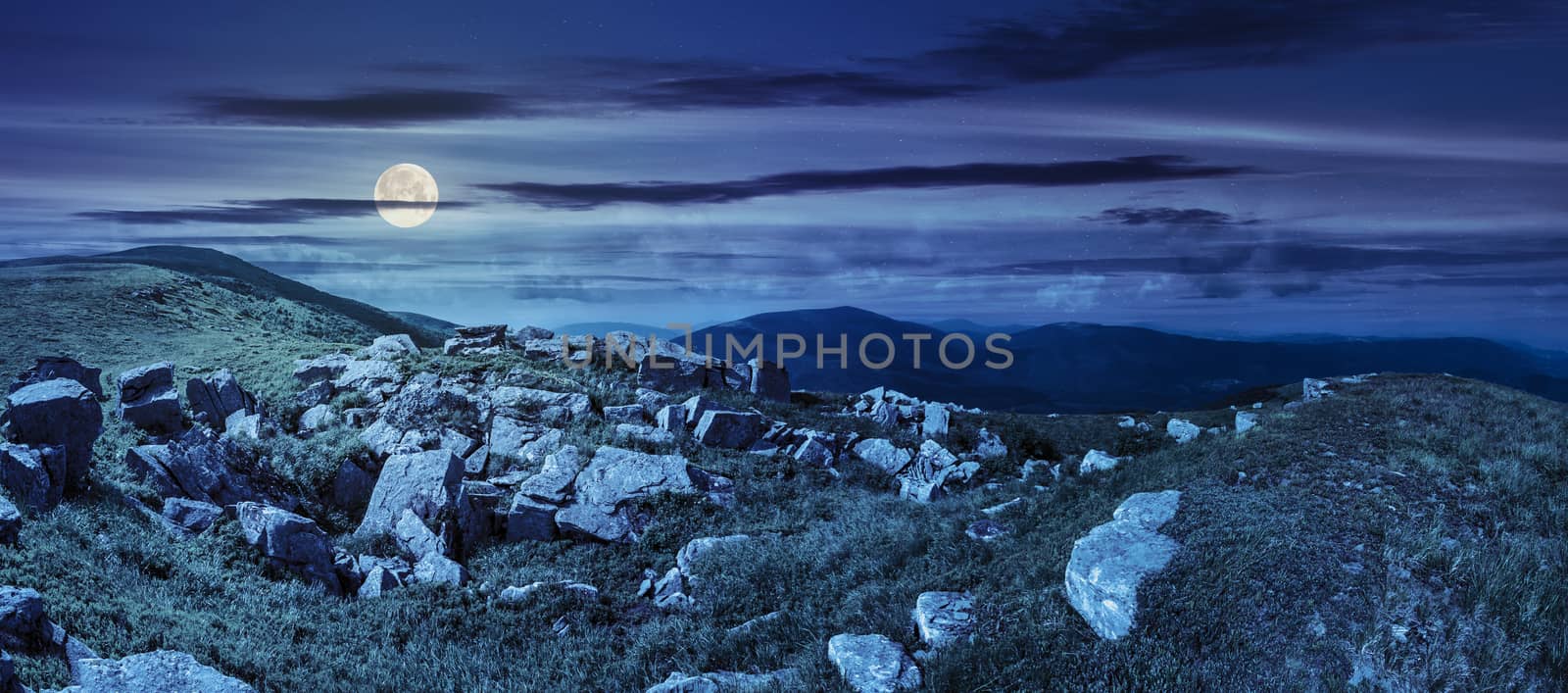 stones in valley on top of mountain range at night by Pellinni