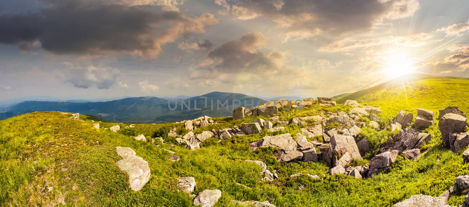 stones in valley on top of mountain range at sunset by Pellinni