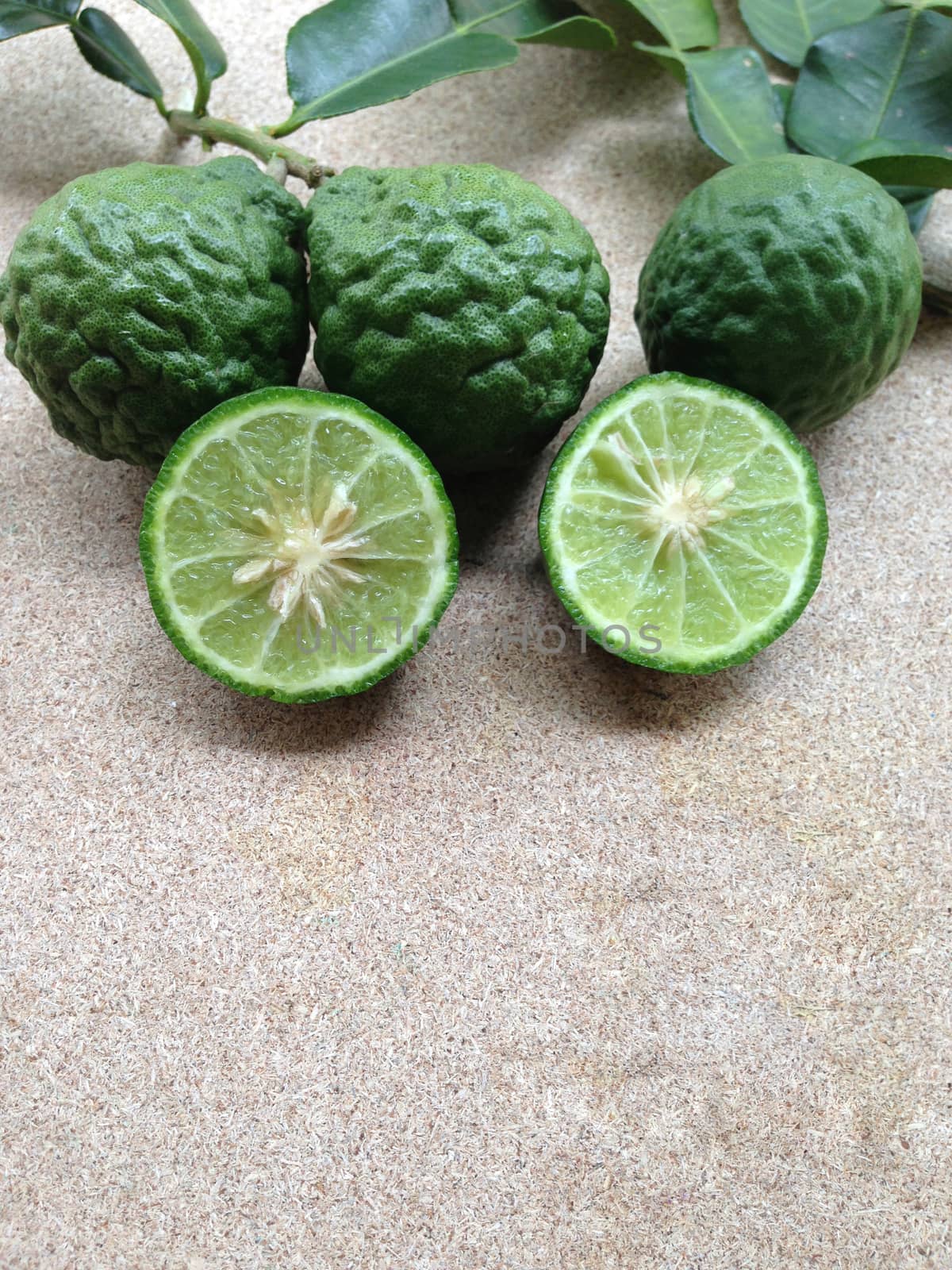 Kaffir Lime or Bergamot on plywood background