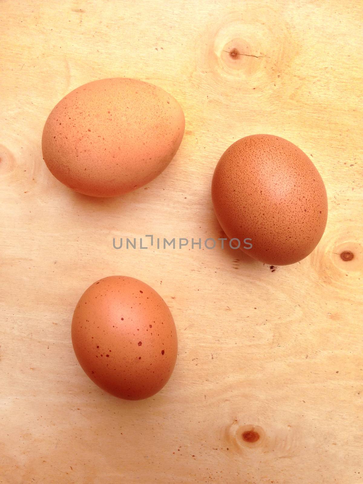 chicken egg a on wooden background by Bowonpat