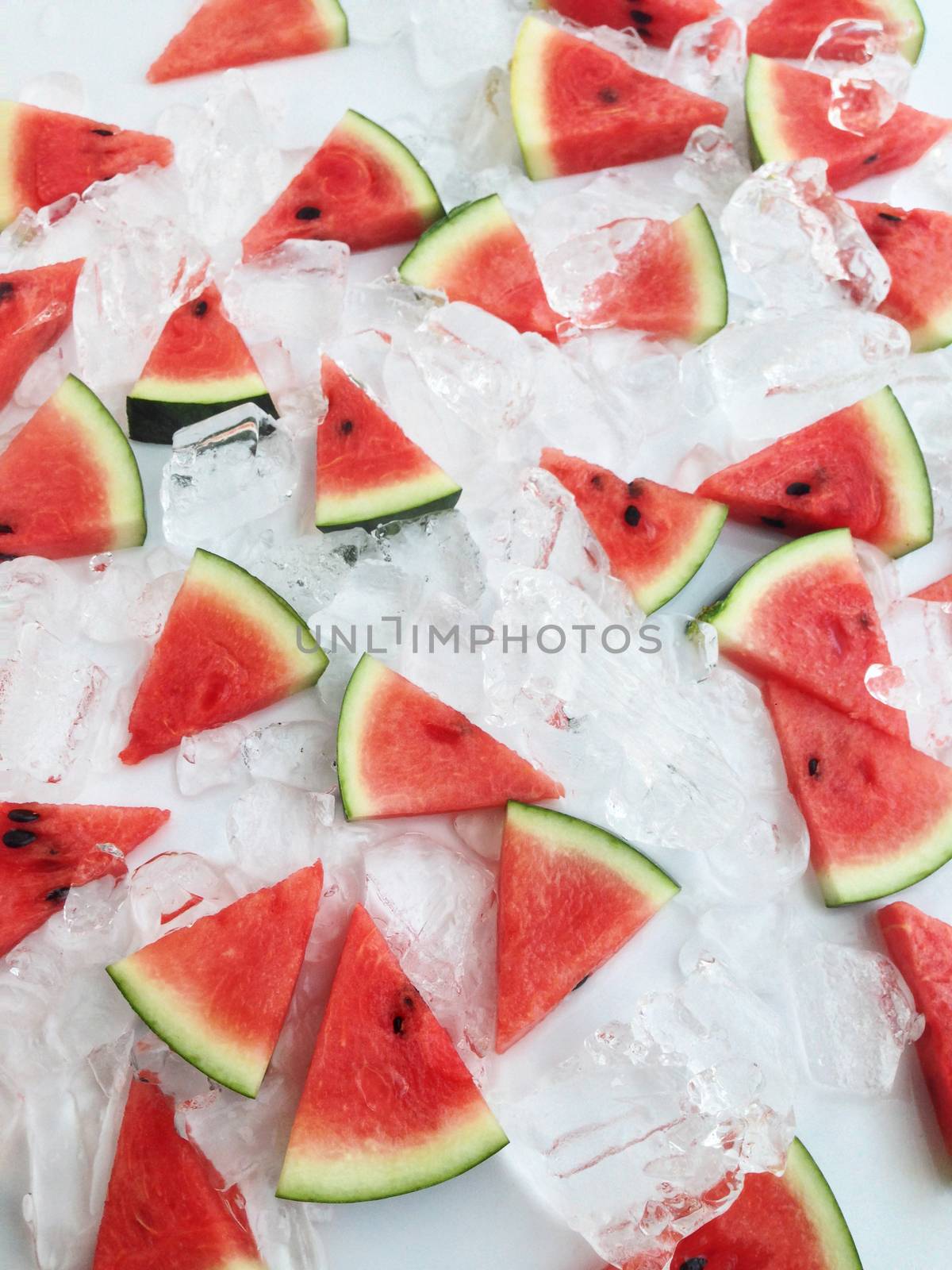 slices of watermelon on ice by Bowonpat