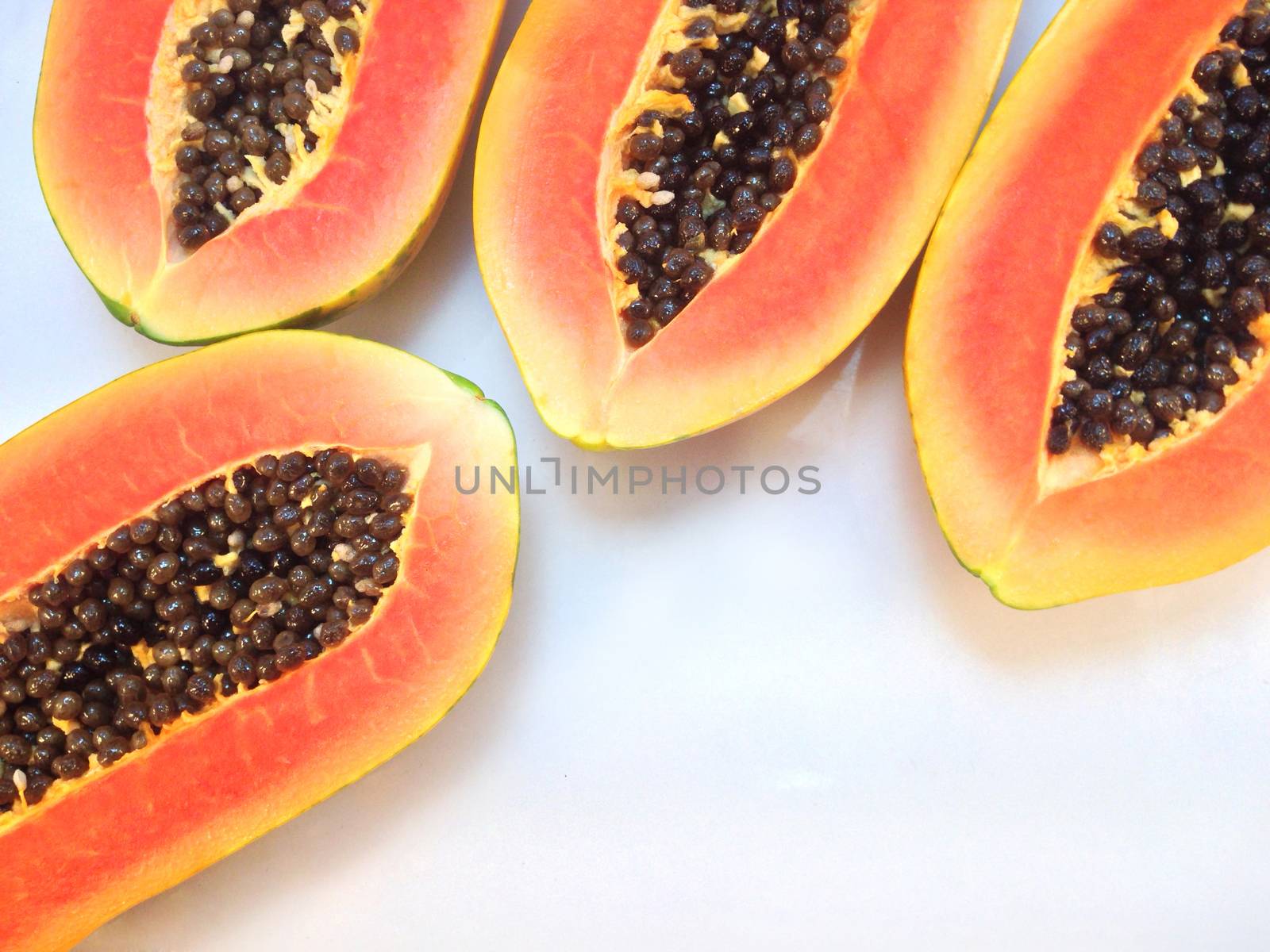 slices of sweet papaya on white background by Bowonpat