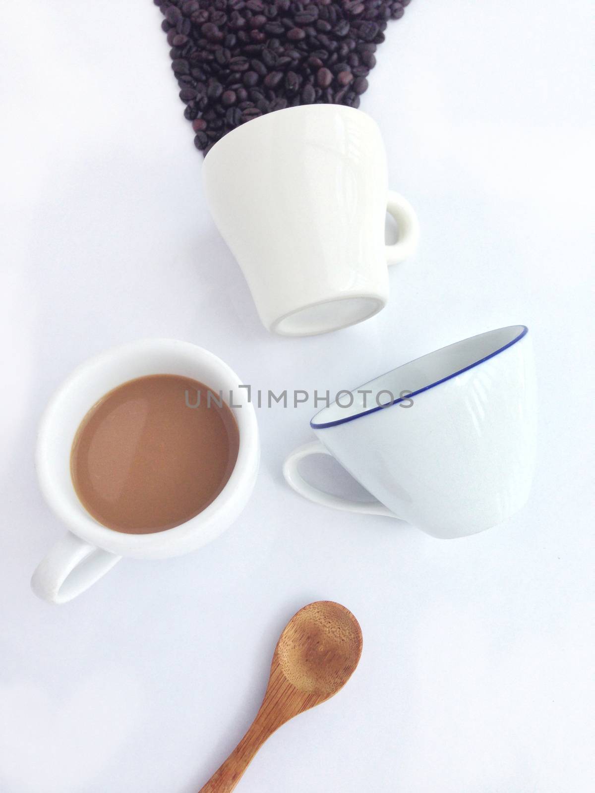cup of coffee and wooden spoon on white background