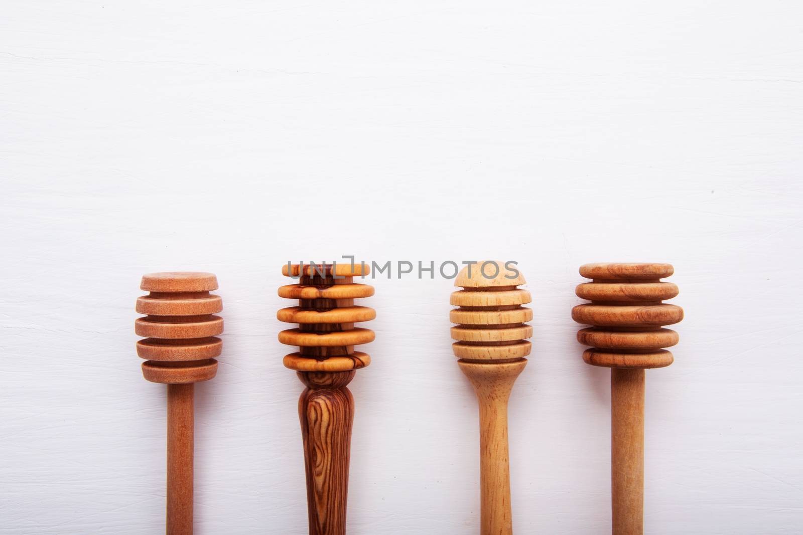 wooden honey stick isolated on white wooden background, Top view with copy space.